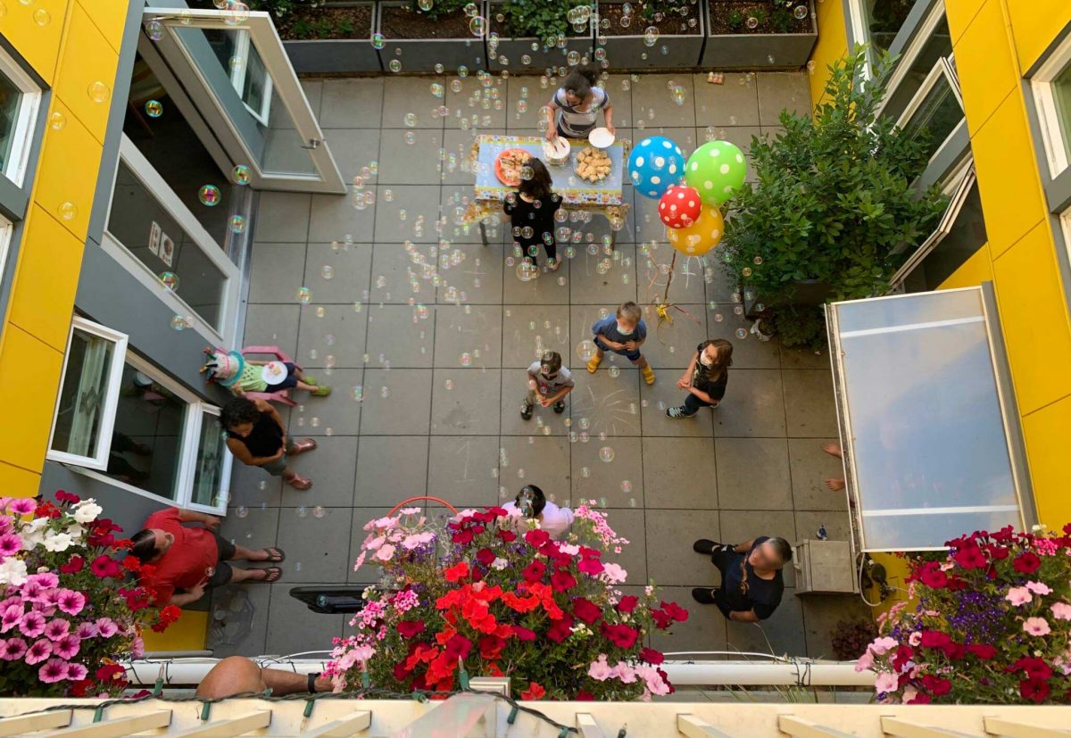 Residents play together in the common courtyard at Capitol Hill Urban Cohousing in Seattle.