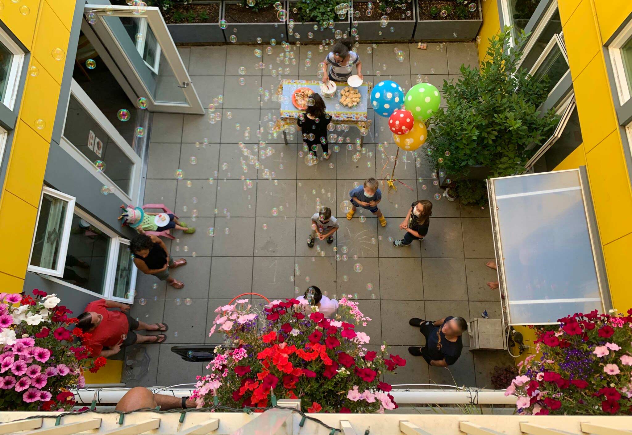 Residents play together in the common courtyard at Capitol Hill Urban Cohousing in Seattle.