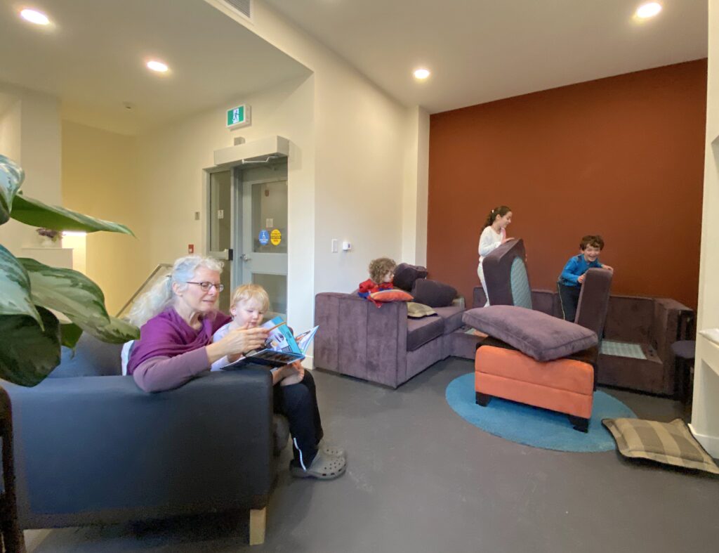 Kids play together in the entry lounge at Little Mountain Cohousing, often building pillow forts or reading books.