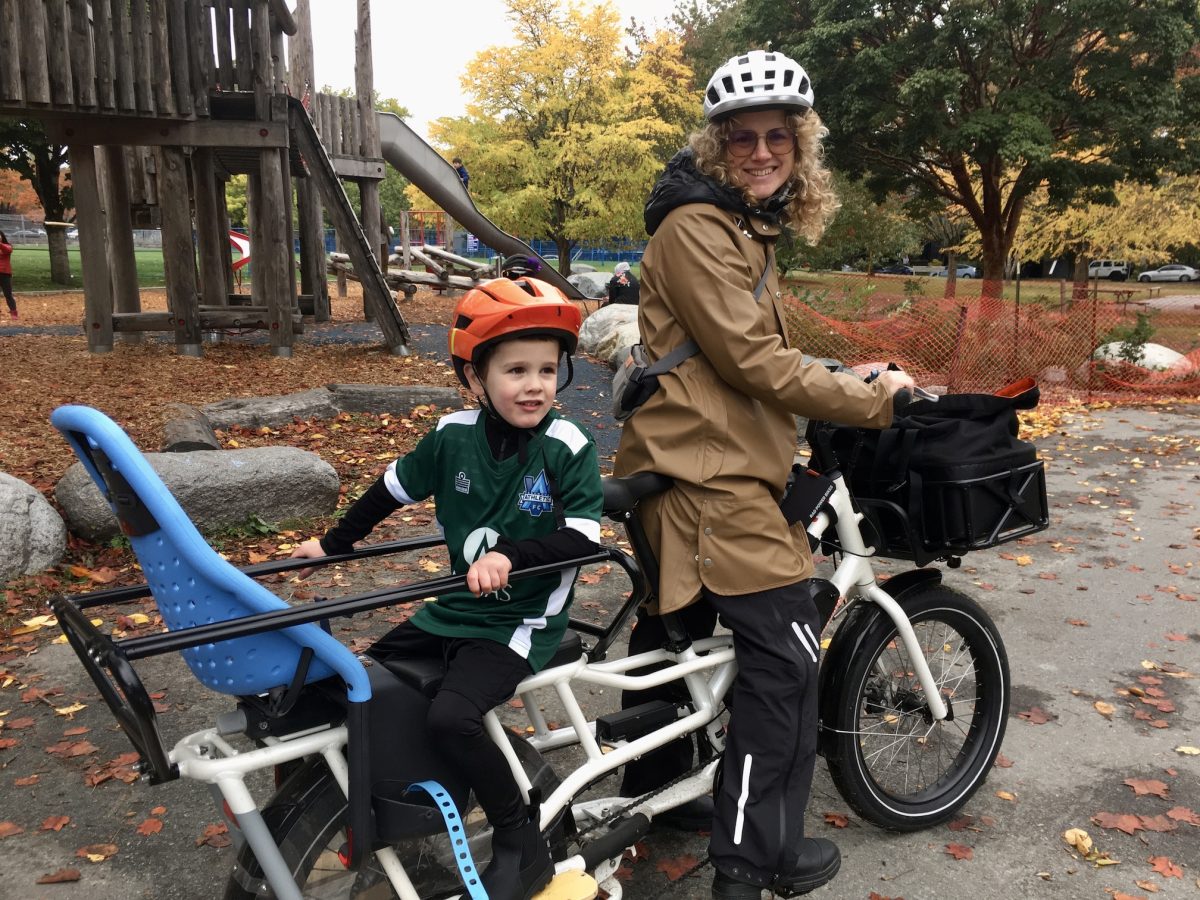 Callista Ottoni rides her e-bike with her son.